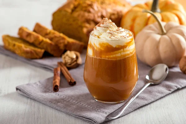 Pumpkin spice latte, hot coffee drink with pumpkins and pumpkin