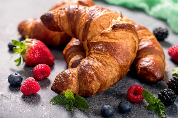 Fresh croissants with berries, delicious breakfast, bakery conce