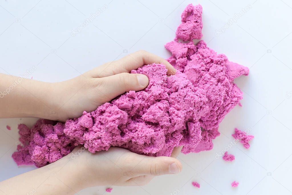 multi-colored molds on kinetic sand. games with a child, early development