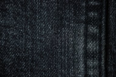 Koyu gri kot pantolona dikiş, yakın plan. Ayrıntılar tekstil, kumaş, seçici odak.