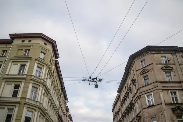 Perspective of a cross street in Wroclaw, Poland with contrast between new and old buildings and wire with street light.