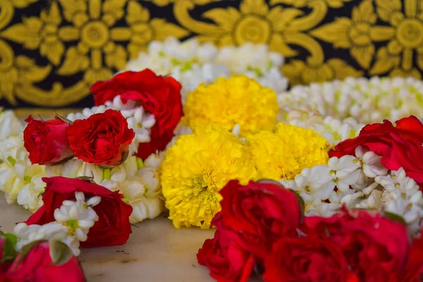 Withe, red and yellow flower offering in a temple