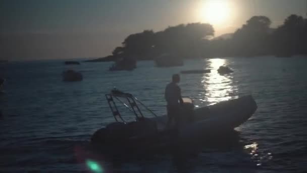 A silhouette of motor boat at sunset — Stock Video