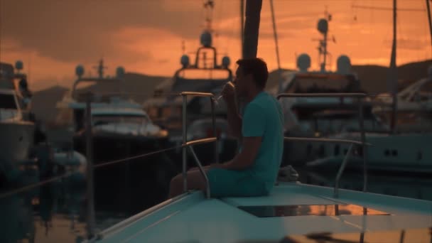 Beau homme sur voilier au coucher du soleil . — Video