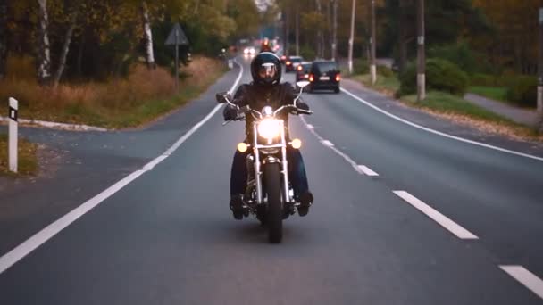 A young man riding a chopper on a road — Stock Video