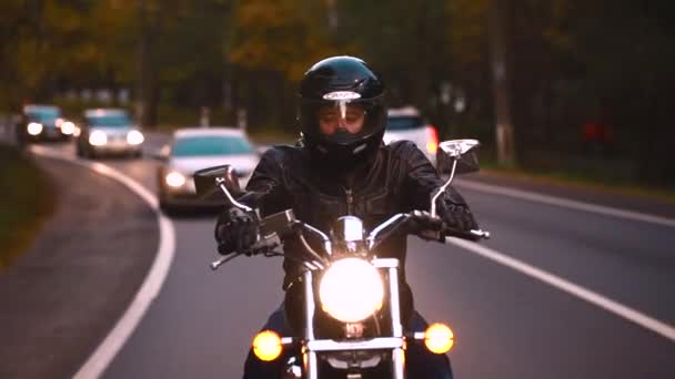 A young man riding a chopper on a road — Stock Video