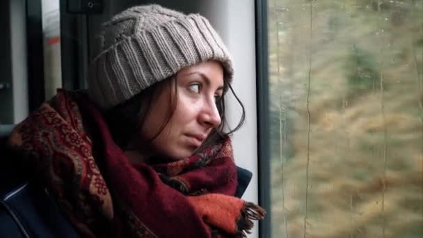 Sad girl tourist is looking out the train window. — Stock Video