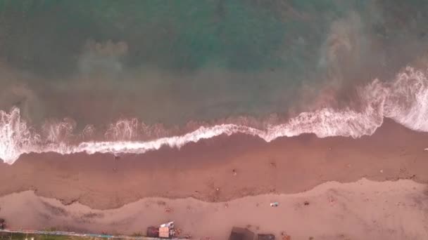 Flying up with blue water and pink sand over Mejan Stone Beach in the Canggu Bali region of Indonesia — Stock Video