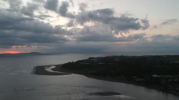 Vuelo en tiempo nublado, en la esquina se puede ver el resplandor del atardecer, derecha Prancak Perancak bali indonesia península — Vídeo de stock