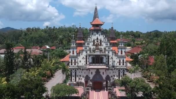 Drone flying away from tropical jungle temple Sacred Heart of Jesus Catholic Church west bali indonesia — Stock Video