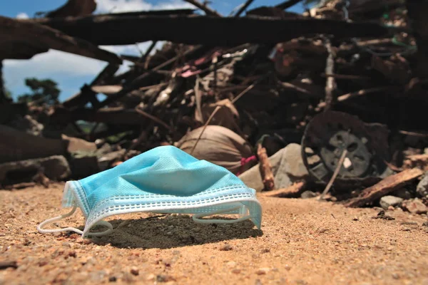 Medical mask in the garbage dump