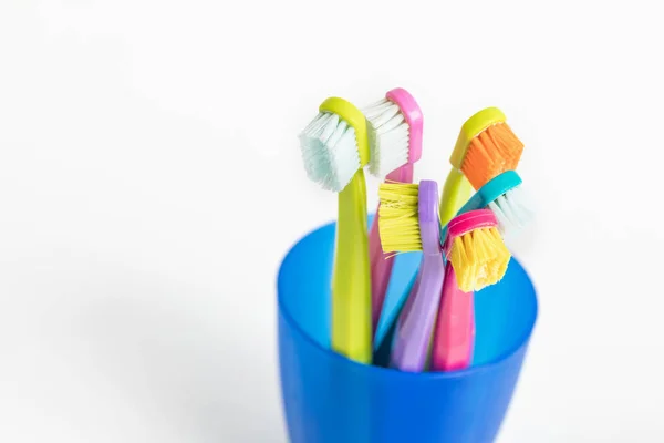 New and used color ultra fine toothbrushes in colorful glasses. Dental Industry. various types of toothbrushes. Beautiful smile concept. Whitening. Tooth care. Teeth healthy concept. — Stock Photo, Image