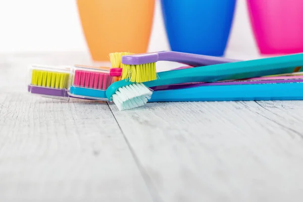 New color ultra fine toothbrushes in colorful glasses. Dental Industry. various types of toothbrushes. Beautiful smile concept. Whitening. Tooth care. Teeth healthy concept. — Stock Photo, Image