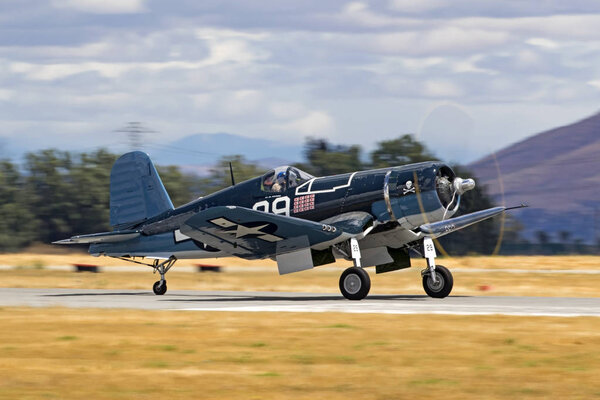 Airplane WWII F4-U Corsair fighter flying at 2017 Air Show