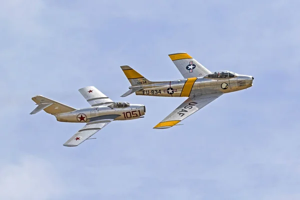 Airplane Cold War MIG and F-86 Sabre jet fighters flying at 2017 Planes of Fame Air Show — Stock Photo, Image