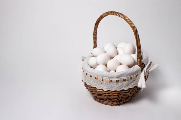 Easter wicker basket from a natural vine with eggs. Beautifully designed baskets in a minimalist style.