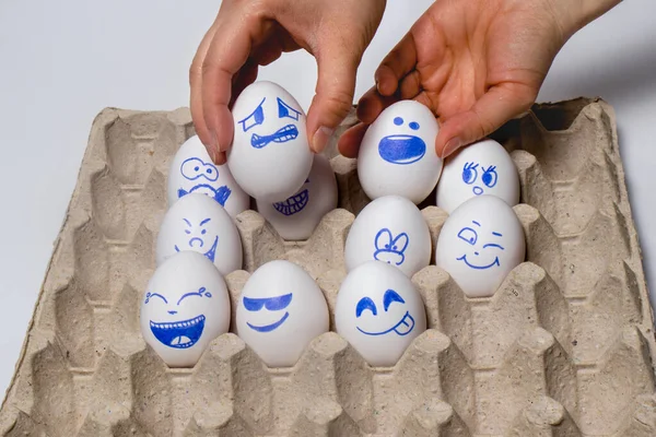 Funny chicken eggs. Smiley eggs with faces, funny faces. Eggs with different emotions: laughter, smiles, fear, anger, scream, tears.
