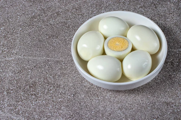 Boiled peeled eggs without shell on a plate. Ingredients for cooking.