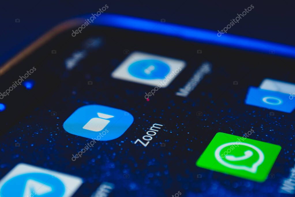 Zoom icon app and other messenger icon app on the screen smartphone closeup. Zoom Video Communications is a company that provides remote conferencing services.