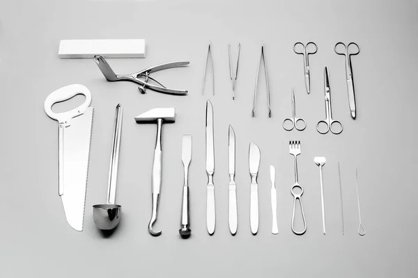 Close-up view on a set of medical tools for surgeon laid on a grey background — Stock Photo, Image