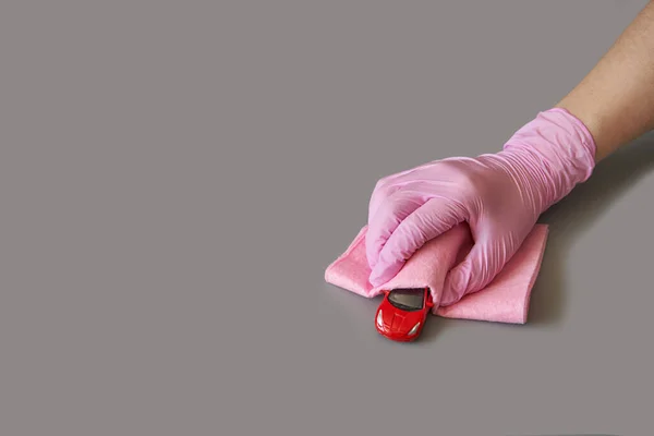 Hand in glove holding toy car. Safety anti virus concept — Stock Photo, Image