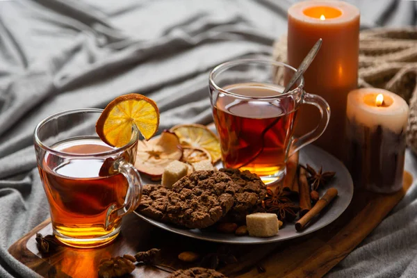 Hot spicy tea in bed with chocolate cookies cinnamon lemon and sugar