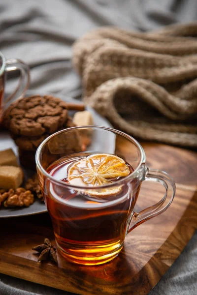 Hot spicy tea in bed with chocolate cookies cinnamon lemon and sugar