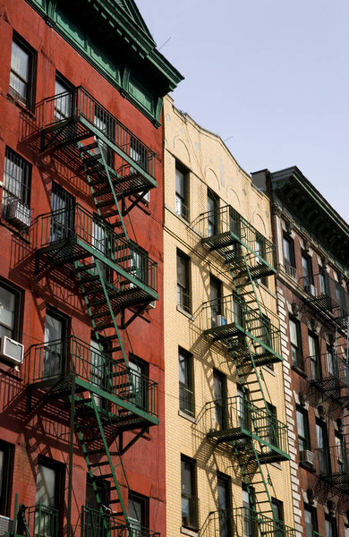 Fire escapes on a row of traditional houses in downtown New York City, New York, USA - 5th March 2010