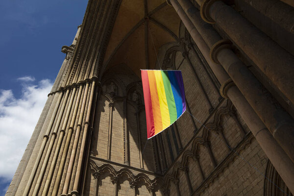 Peterborough, Cambridgeshire, United Kingdom, July 2019, A view of a Pride flag hanging from Peterborough Cathedra