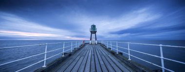 Whitby, Kuzey Yorkshire, İngiltere, 22 Mart 2019, Whitby balıkçı kasabasındaki liman duvarı ve rıhtım manzarası