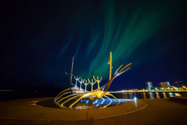 REYKJAVIK, ICELAND - SEP 2016 : Sculpture of Sun Voyager in Reykjavik, Iceland with aurora on Septmber 26, 2016 , designed by Jon Gunnar Arnason  clipart