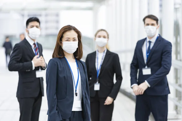 A team of multinational business people wearing masks to prevent infection