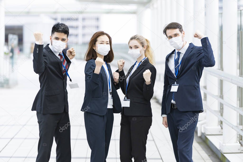 A team of multinational business people wearing masks to prevent infection