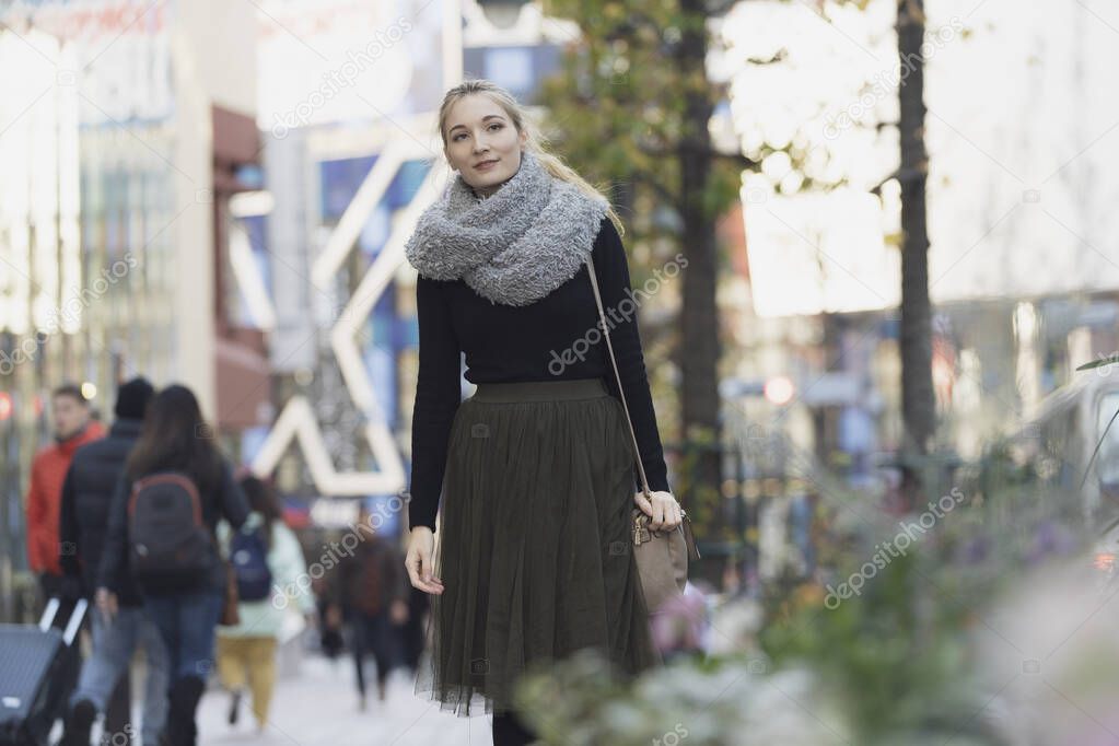 Portrait of a young woman sightseeing in Shibuya (Tokyo, Japan)