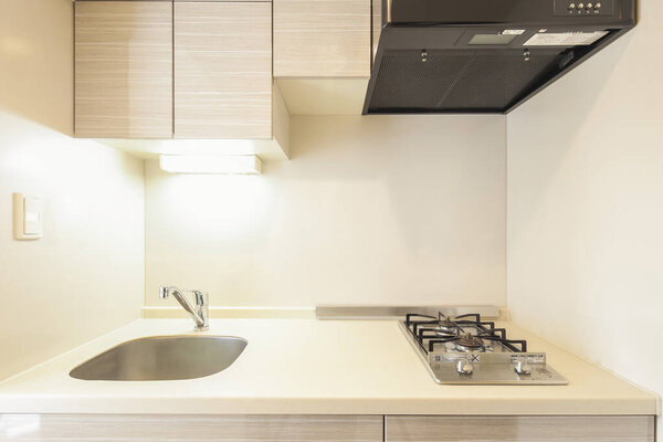 A bright and clean kitchen in a white-toned apartment room