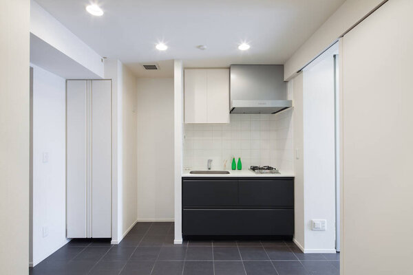 A bright and clean kitchen in a white-toned apartment room