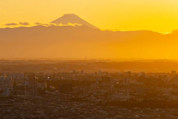 Evening urban landscape with silhouettes of Tokyo city and Mount Fuji