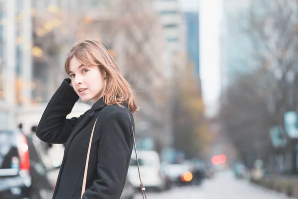 Caucasian young woman walking in the business district of Tokyo, Japan