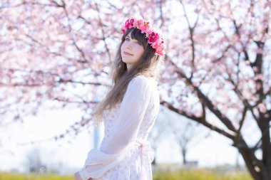 Genç beyaz kadın portresi, kiraz çiçekleri açmış.