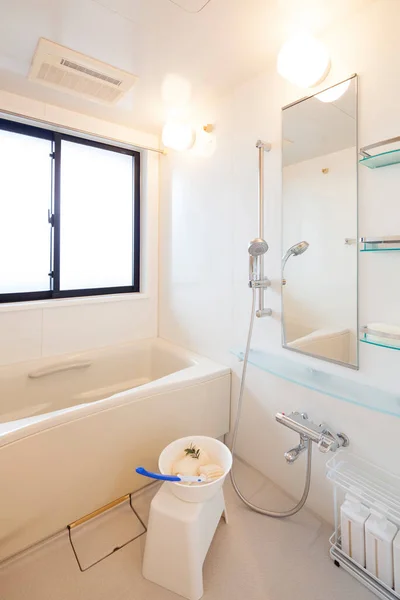 Wide angle photo of bright and cleanly cleaned bathroom with shower and bathtub