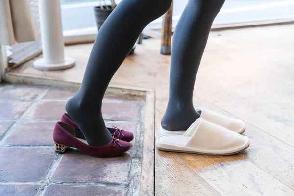 Woman Who Comes Home Takes Her Shoes Wears Indoor Slippers — Stock Photo, Image