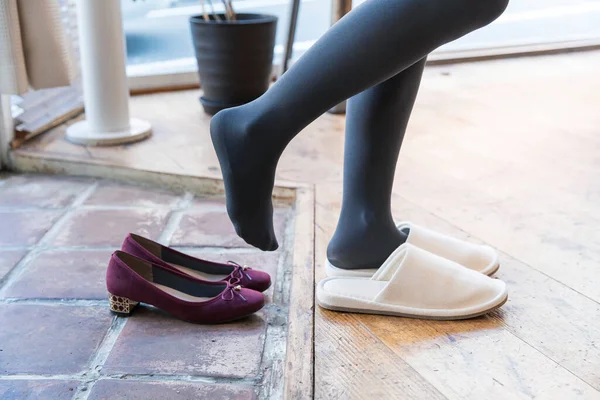 Woman Who Comes Home Takes Her Shoes Wears Indoor Slippers — Stock Photo, Image