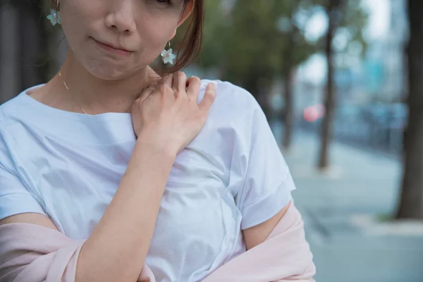 asian woman suffering from stiff shoulders and stiff neck
