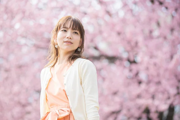 春にはアジアの若い女性が満開の桜を楽しむ — ストック写真