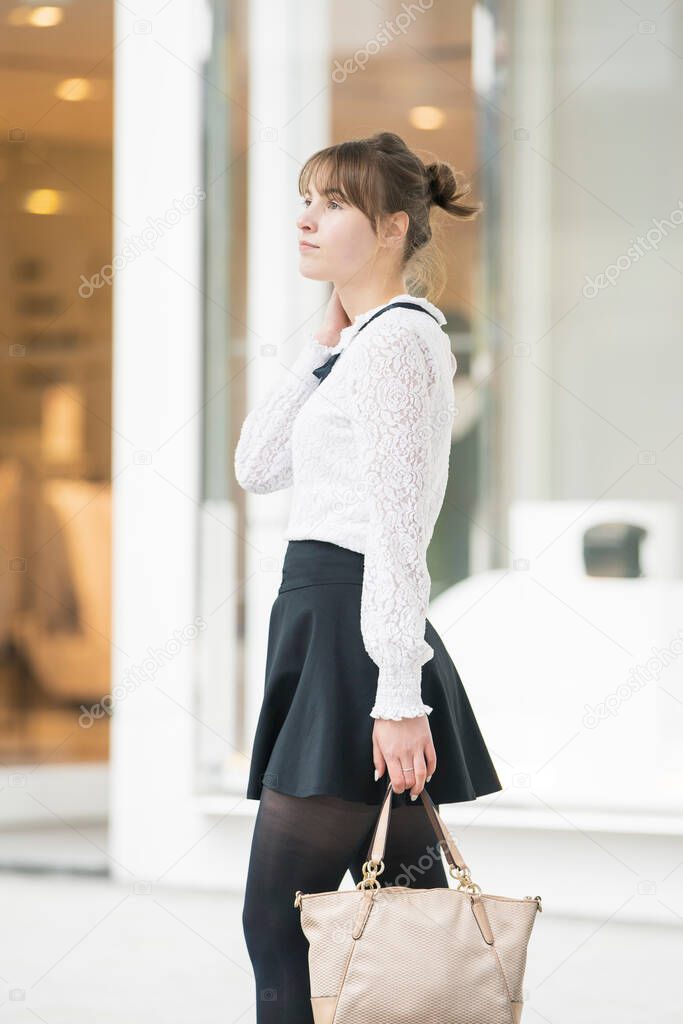 Caucasian young woman walking on a shopping street in Shibuya, Tokyo