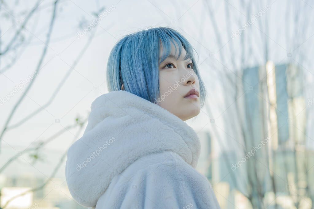 Young Asian woman with blue hair in Shibuya (Tokyo, JAPAN)