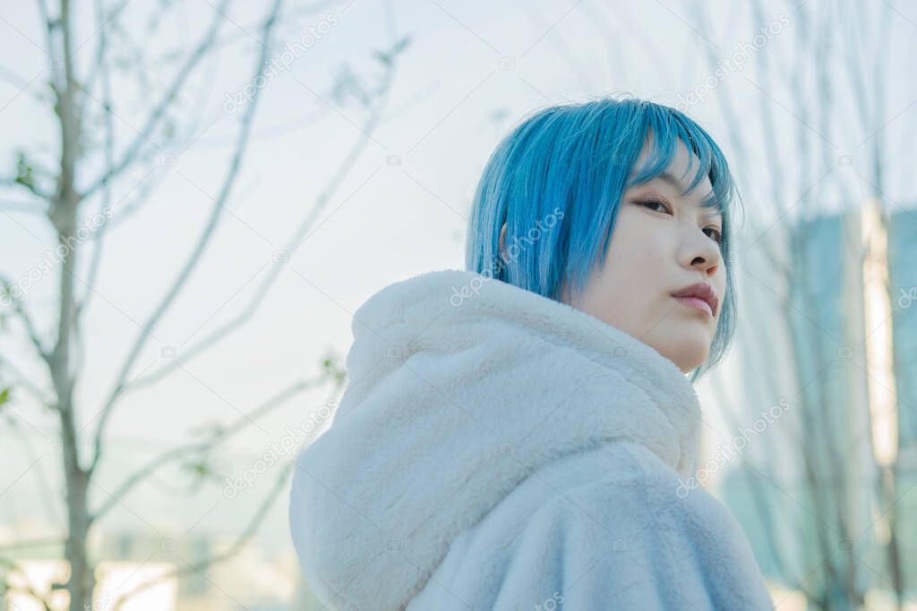 Young Asian woman with blue hair in Shibuya (Tokyo, JAPAN)