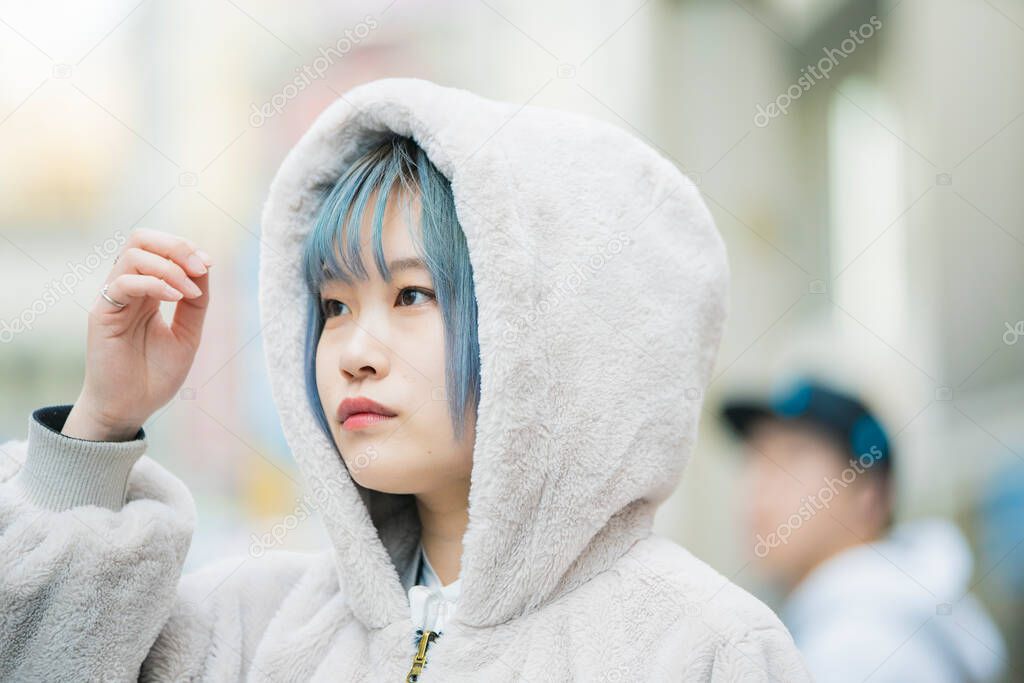 Young Asian woman with blue hair in Shibuya (Tokyo, JAPAN)