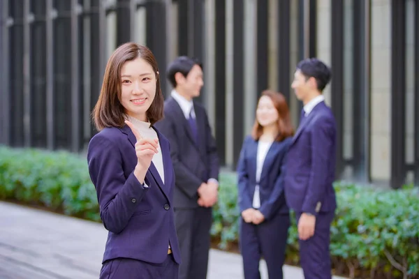 Portrait of Asian business woman in suit and her team