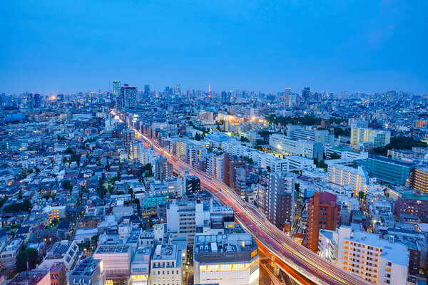 A landscape photo that overlooks the night view of a Japanese city